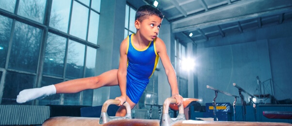 Elementary school student practicing artistic gymnastic